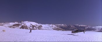 Movie still from “Alaska” (1996), directed by Fraser C. Heston – Two skiers are skiing on a snowy slope; Extreme Wide shot, High angle
