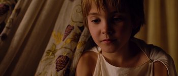Movie still from “Alexander” (2004), directed by Oliver Stone – A little girl laying in a bed with a blanket; Close Up shot, High angle