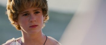 Movie still from “Alexander” (2004), directed by Oliver Stone – A young person's face with a blurry background; Close Up shot, Over the shoulder angle