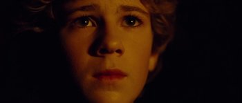 Movie still from “Alexander” (2004), directed by Oliver Stone – A person's face in the dark; Extreme Close Up shot, High angle