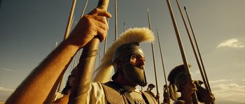 Movie still from “Alexander” (2004), directed by Oliver Stone – A man with a helmet on holding a spear; Medium shot, Low angle