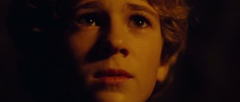 Movie still from “Alexander” (2004), directed by Oliver Stone – A person's face in the dark; Close Up shot, Low angle