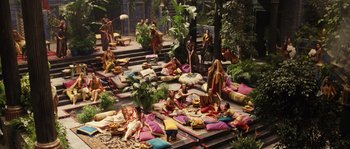 Movie still from “Alexander” (2004), directed by Oliver Stone – A group of people sitting on the ground in a park; Extreme Wide shot, High angle