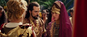 Movie still from “Alexander” (2004), directed by Oliver Stone – A man and a woman dressed in ancient clothing; Close Up shot, Over the shoulder angle