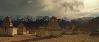 Movie still from “Alexander” (2004), directed by Oliver Stone – A view of a mountain range from the desert; Extreme Wide shot, Low angle