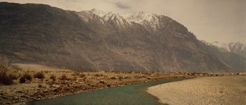 Movie still from “Alexander” (2004), directed by Oliver Stone – A river running through the middle of the desert; Extreme Wide shot, High angle