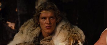 Movie still from “Alexander” (2004), directed by Oliver Stone – A man with long blonde hair wearing a fur coat; Close Up shot, Low angle