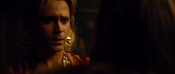 Movie still from “Alexander” (2004), directed by Oliver Stone – A person wearing a red and gold shirt; Close Up shot, Over the shoulder angle