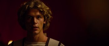Movie still from “Alexander” (2004), directed by Oliver Stone – A young man with blonde curly hair wearing roman clothes; Close Up shot, Over the shoulder angle