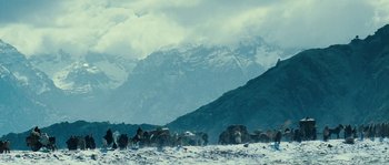 Movie still from “Alexander” (2004), directed by Oliver Stone – A herd of cattle standing on top of a snow covered slope; Extreme Wide shot, Low angle