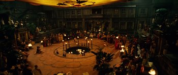 Movie still from “Alexander” (2004), directed by Oliver Stone – A group of people standing in a circle with candles; Extreme Wide shot, High angle