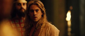 Movie still from “Alexander” (2004), directed by Oliver Stone – A person with long blonde hair; Close Up shot, Over the shoulder angle