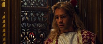 Movie still from “Alexander” (2004), directed by Oliver Stone – A person with long blonde hair; Close Up shot, High angle