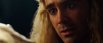 Movie still from “Alexander” (2004), directed by Oliver Stone – A man with long blonde hair stares into the camera; Close Up shot, Overhead angle