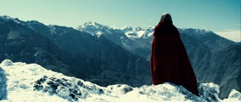 Movie still from “Alexander” (2004), directed by Oliver Stone – A person standing on top of a snow covered slope; Extreme Wide shot, Low angle