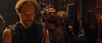 Movie still from “Alexander” (2004), directed by Oliver Stone – A group of men standing next to each other; Medium shot, Over the shoulder angle