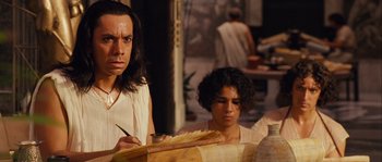 Movie still from “Alexander” (2004), directed by Oliver Stone – A man and a woman are painting in a room; Close Up shot, Over the shoulder angle