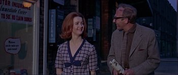 Movie still from “Alfie” (1966), directed by Lewis Gilbert – A man and a woman walking down a street; Medium shot, Low angle