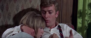 Movie still from “Alfie” (1966), directed by Lewis Gilbert – A man and a woman sitting next to each other on a couch; Close Up shot, Low angle