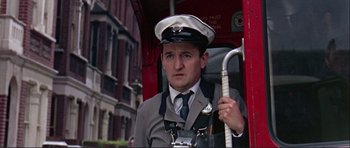 Movie still from “Alfie” (1966), directed by Lewis Gilbert – A man in a uniform holding a fire hydrant; Close Up shot, Low angle