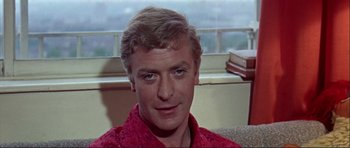 Movie still from “Alfie” (1966), directed by Lewis Gilbert – A person wearing a red shirt; Close Up shot, Over the shoulder angle