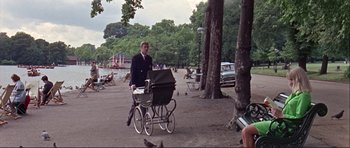 Movie still from “Alfie” (1966), directed by Lewis Gilbert – A man pushing a baby carriage in a park; Wide shot, High angle