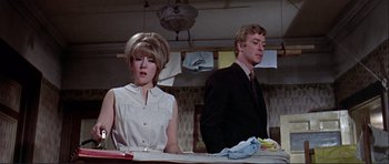 Movie still from “Alfie” (1966), directed by Lewis Gilbert – A man and a woman standing at a counter; Medium shot, Low angle