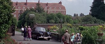 Movie still from “Alfie” (1966), directed by Lewis Gilbert – An old car parked in front of a building; Extreme Wide shot, Low angle
