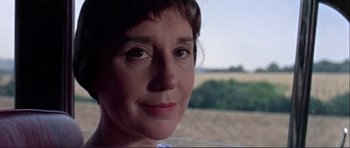 Movie still from “Alfie” (1966), directed by Lewis Gilbert – A woman's face in front of an open field; Close Up shot, Low angle