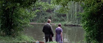 Movie still from “Alfie” (1966), directed by Lewis Gilbert – A man and a woman standing next to a body of water; Wide shot, High angle