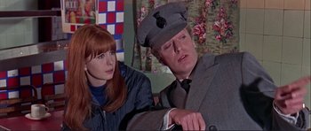 Movie still from “Alfie” (1966), directed by Lewis Gilbert – A man and a woman sitting next to each other in a room; Close Up shot, Low angle
