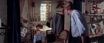Movie still from “Alfie” (1966), directed by Lewis Gilbert – A man and a woman are in a bedroom; Medium shot, High angle
