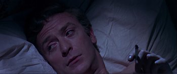 Movie still from “Alfie” (1966), directed by Lewis Gilbert – A person laying in a bed; Close Up shot, Overhead angle