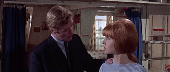 Movie still from “Alfie” (1966), directed by Lewis Gilbert – A man and a woman are standing in a room; Medium shot, Low angle