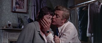 Movie still from “Alfie” (1966), directed by Lewis Gilbert – A man and a woman are kissing in a room; Close Up shot, Over the shoulder angle