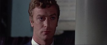 Movie still from “Alfie” (1966), directed by Lewis Gilbert – A person wearing a suit and tie; Close Up shot, Low angle