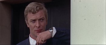 Movie still from “Alfie” (1966), directed by Lewis Gilbert – A person wearing a suit and tie; Close Up shot, Low angle