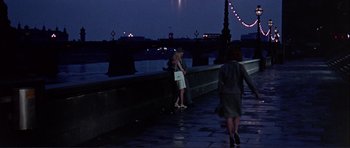 Movie still from “Alfie” (1966), directed by Lewis Gilbert – Two women are standing on a bridge at night; Wide shot, High angle