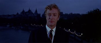 Movie still from “Alfie” (1966), directed by Lewis Gilbert – A person wearing a suit and tie; Close Up shot, Low angle