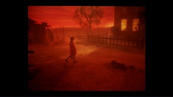 Movie still from “Alice Doesn't Live Here Anymore” (1974), directed by Martin Scorsese – A person walking on a dirt road near a building; Extreme Wide shot, High angle
