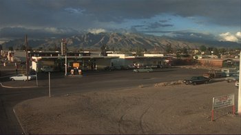 Movie still from “Alice Doesn't Live Here Anymore” (1974), directed by Martin Scorsese – An empty parking lot with mountains in the background; Extreme Wide shot, High angle