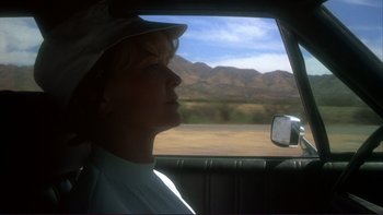 Movie still from “Alice Doesn't Live Here Anymore” (1974), directed by Martin Scorsese – A woman sitting in the passenger seat of a car looking out the window; Close Up shot, Low angle