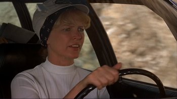 Movie still from “Alice Doesn't Live Here Anymore” (1974), directed by Martin Scorsese – A woman driving a car wearing a baseball cap; Close Up shot, Low angle