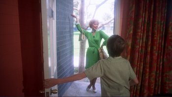 A woman in a green dress and a boy in a green shirt