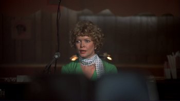 Movie still from “Alice Doesn't Live Here Anymore” (1974), directed by Martin Scorsese – A woman in a green shirt and a white polka dot neck tie; Close Up shot, Over the shoulder angle
