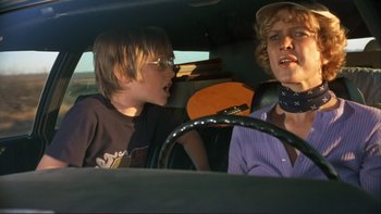 Movie still from “Alice Doesn't Live Here Anymore” (1974), directed by Martin Scorsese – Two young boys in a car talking to each other; Medium shot, Low angle