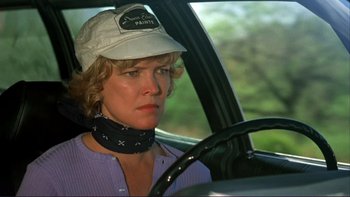 Movie still from “Alice Doesn't Live Here Anymore” (1974), directed by Martin Scorsese – A woman wearing a hat sitting in the driver's seat of a car; Close Up shot, Over the shoulder angle