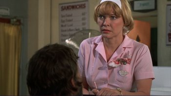 Movie still from “Alice Doesn't Live Here Anymore” (1974), directed by Martin Scorsese – A woman in a pink shirt is talking to a man; Close Up shot, Over the shoulder angle