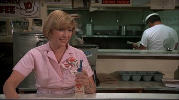Movie still from “Alice Doesn't Live Here Anymore” (1974), directed by Martin Scorsese – A woman sitting at a counter in a restaurant; Medium shot, Over the shoulder angle