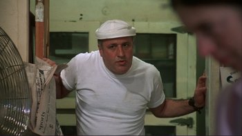 Movie still from “Alice Doesn't Live Here Anymore” (1974), directed by Martin Scorsese – A man in a white shirt and a white hat; Close Up shot, Low angle